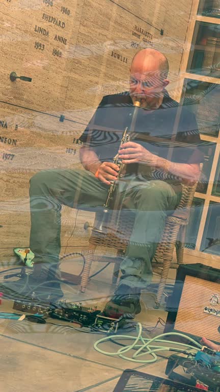 Evan Ziporyn performing within water imagery